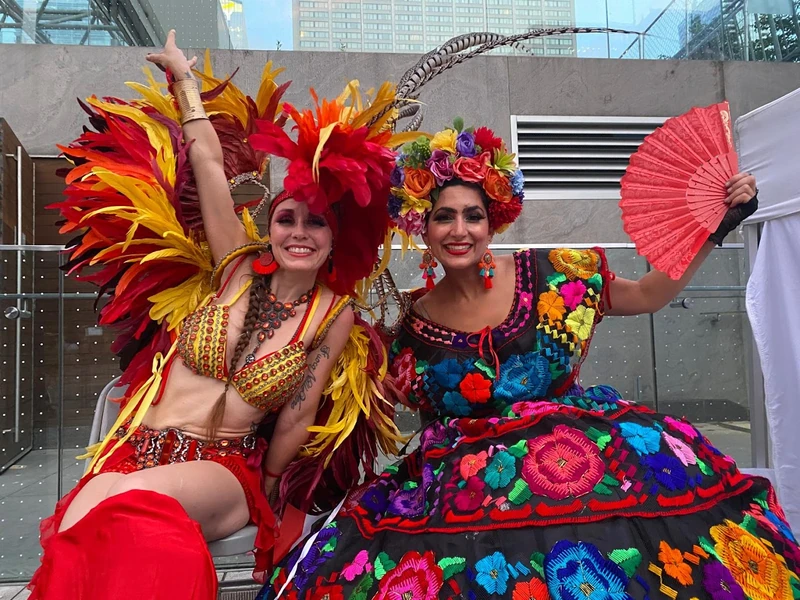 Vibrant carnival performers in feathered and floral costumes