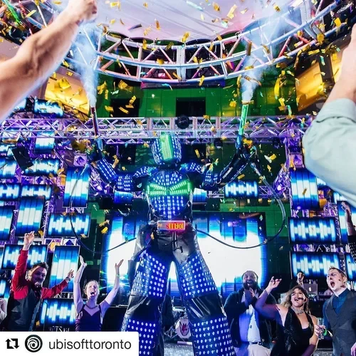 LED Robot stilt performer towering above crowd at nightclub