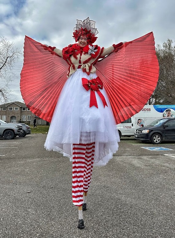 Hire circus performers toronto Hala on stilts entertainment stiltwalkers poinsettia princess