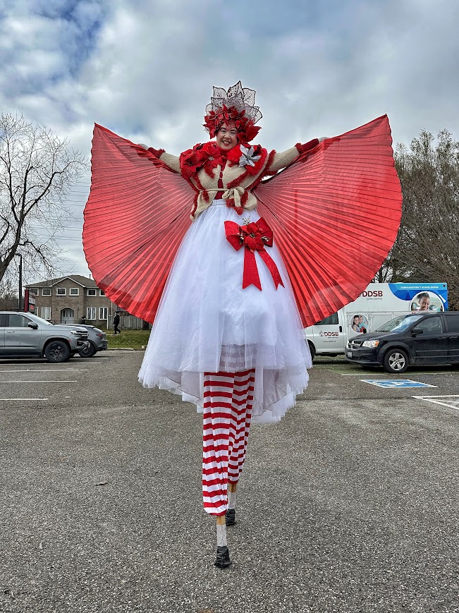 Hire circus performers toronto Hala on stilts entertainment stiltwalkers poinsettia princess